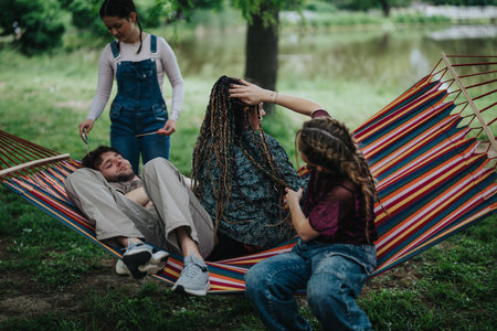 Friends relaxing together on a hammock in a peaceful park setting