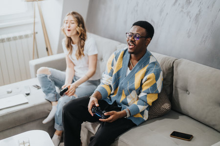 Diverse couple enjoying a gaming session together at home on a cozy couch
