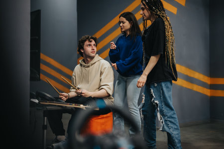 Group of friends gathered around a music setup exploring rhythm and melody