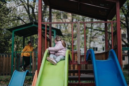 Mother and daughter enjoying time together at a playground in the parkの写真素材
