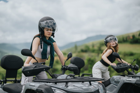 Friends enjoying a thrilling quad bike ride through scenic outdoor landscapesの写真素材