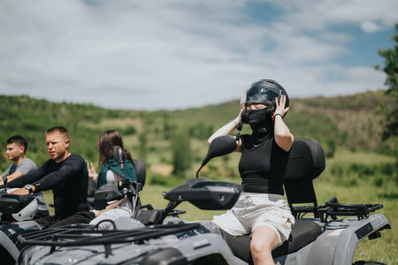 Group of friends enjoying off-road adventure on quad bikes outdoors