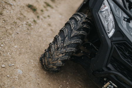 Close-up of an off-road vehicle tire on a dirt trailの写真素材