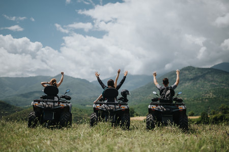 Friends enjoying a quad bike adventure in a scenic mountain locationの写真素材
