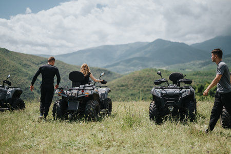 Friends exploring nature while riding quads on a scenic countryside trailの写真素材