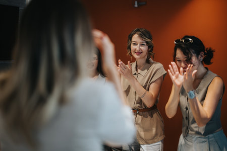 Group of happy women clapping hands during a team gathering