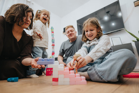 Family enjoying time together playing with building blocks at homeの写真素材