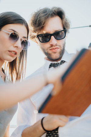 Two people collaborating with a digital tablet during a rooftop meeting