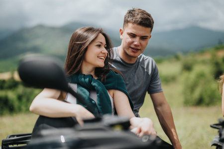 Friends bonding outdoors while enjoying a quad bike adventure in the countrysideの写真素材