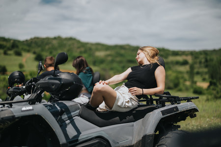 Friends enjoying quad bike adventure outdoors on a sunny day