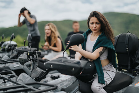 Group of friends riding quad bikes in scenic outdoor landscapeの写真素材