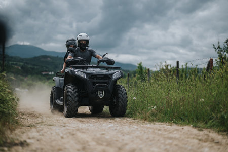 Two riders enjoying an outdoor ATV adventure on a dirt path