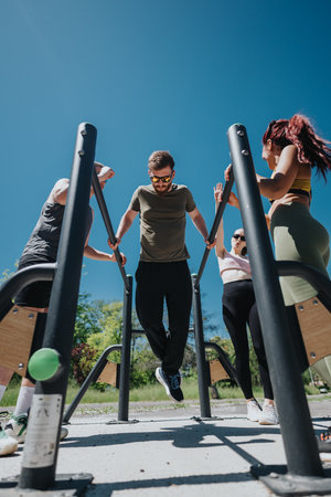 Group exercise session at an outdoor fitness park under clear blue skies