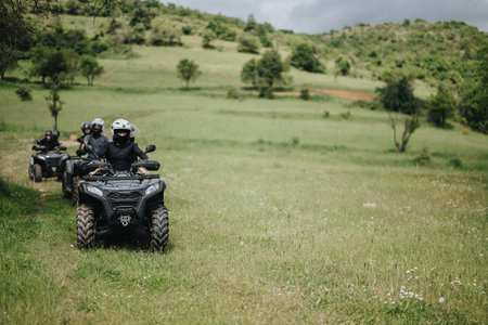 Group riding quad bikes through a scenic grassy field on an outdoor adventure