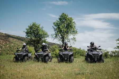 Group of friends riding quad bikes in a scenic countryside setting