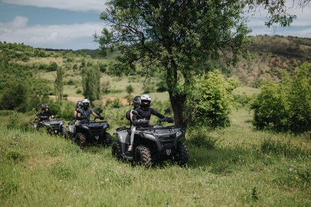 Group of friends riding quad bikes through a scenic countryside trail