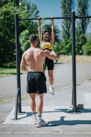 Couple exercising with resistance bands at an outdoor fitness parkの写真素材