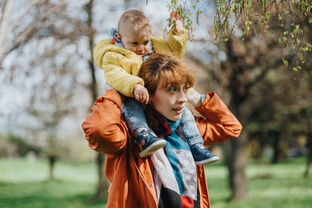Mother with young child enjoying time together outdoors in natureの写真素材