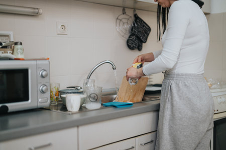 Woman preparing food in a modern kitchen during a home cooking sessionの写真素材