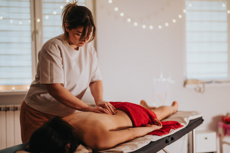 Relaxing massage therapy in a cozy and tranquil wellness settingの写真素材