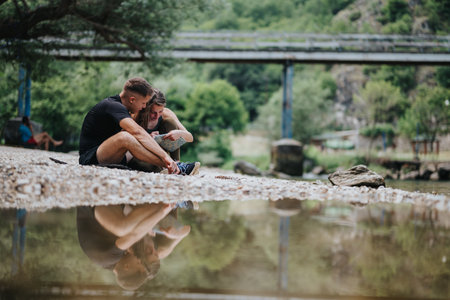 Couple Exploring Nature Together by Riverbank with Scenic Viewの写真素材