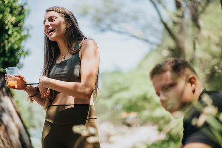Two individuals enjoying a lively conversation outdoors on a sunny dayの写真素材