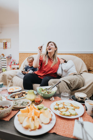 Relaxed family gathering around table with fresh food and joyful conversationsの写真素材