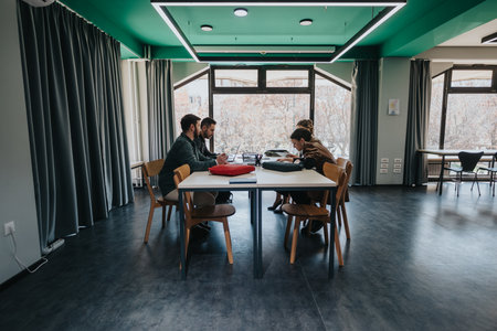 Group of young people collaborating in a modern study roomの写真素材