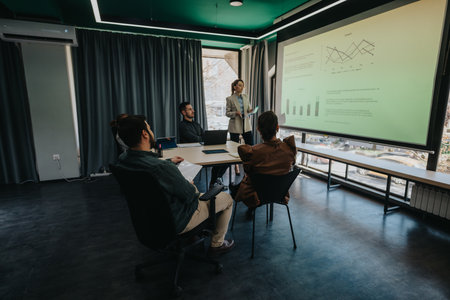 Business team attending a presentation in a modern office conference roomの写真素材