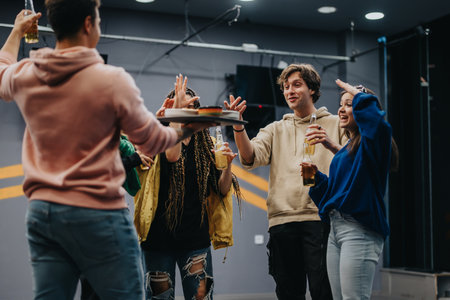 Group of friends sharing drinks and enjoying each others company indoorsの写真素材