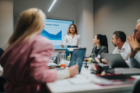 Business presentation in a modern office with a woman presenting to a team at a conference table