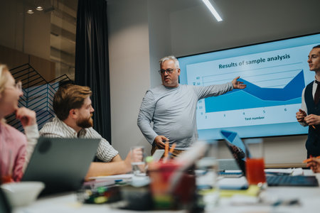 Business presentation in a modern office as a presenter explains a chart to colleagues