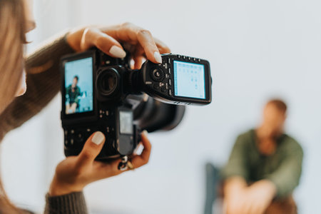 Photographer Capturing a Man during a Studio Sessionの写真素材