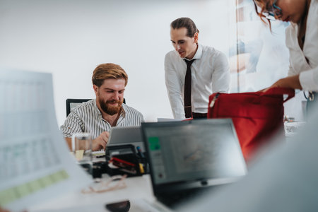 Team of professionals collaborates in a modern office, reviewing documents and discussing a project togetherの写真素材