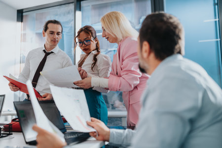 Team of professionals collaborates on documents during a business meeting in a modern office