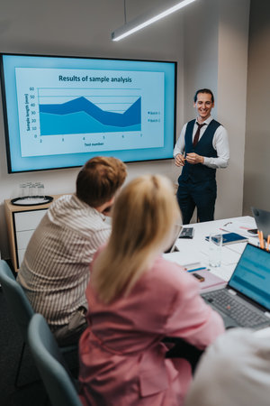 Business presentation in a modern office showing chart analysis during a team meetingの写真素材