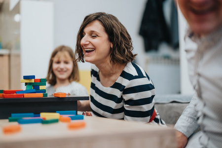 Happy family enjoying quality time together playing with colorful blocksの写真素材