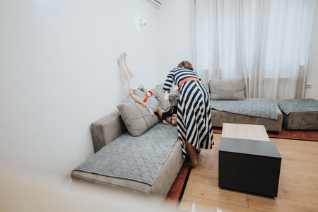 Family interaction in a cozy home environment with playful momentsの写真素材