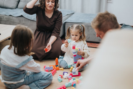 Family spending quality time together playing with toys on the living room floorの写真素材