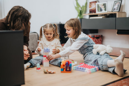 Family playing with colorful block toys together at homeの写真素材