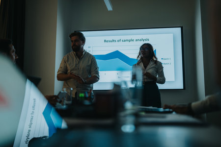 Business presentation in a modern meeting room showing data analysis and teamworkの写真素材