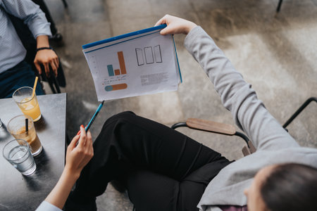 Business discussion featuring a presentation of graphs in a collaborative environmentの写真素材