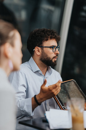 Business discussion over digital device during a modern outdoor meeting sessionの写真素材