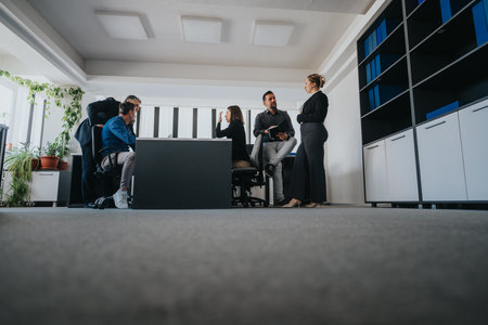 Diverse business team collaborating during a meeting in modern office spaceの写真素材