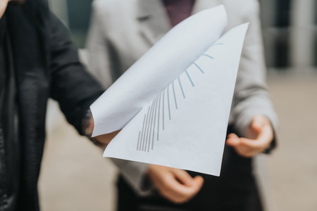 Close-Up of Business Discussion with Chart Document in Focusの写真素材