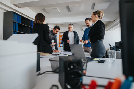 Professional team collaborating on a project in a modern office setupの写真素材