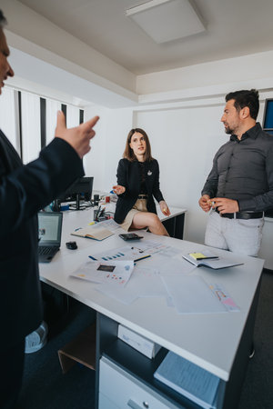 Business professionals collaborating during a brainstorming session in a modern officeの写真素材