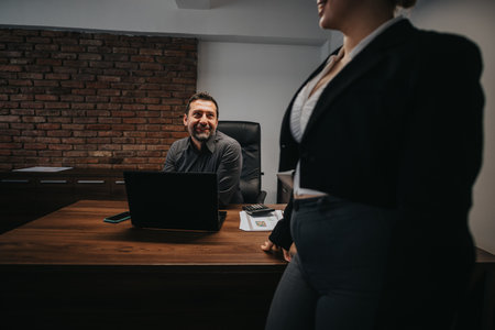 Professional interaction between business colleagues in office setting with modern decorの写真素材