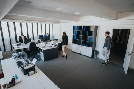 Modern office environment with a business team collaborating on various tasksの写真素材