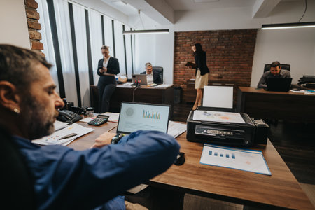Team of professionals working together in a modern office environmentの写真素材